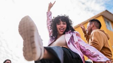 
		Young woman dancing happily
	
